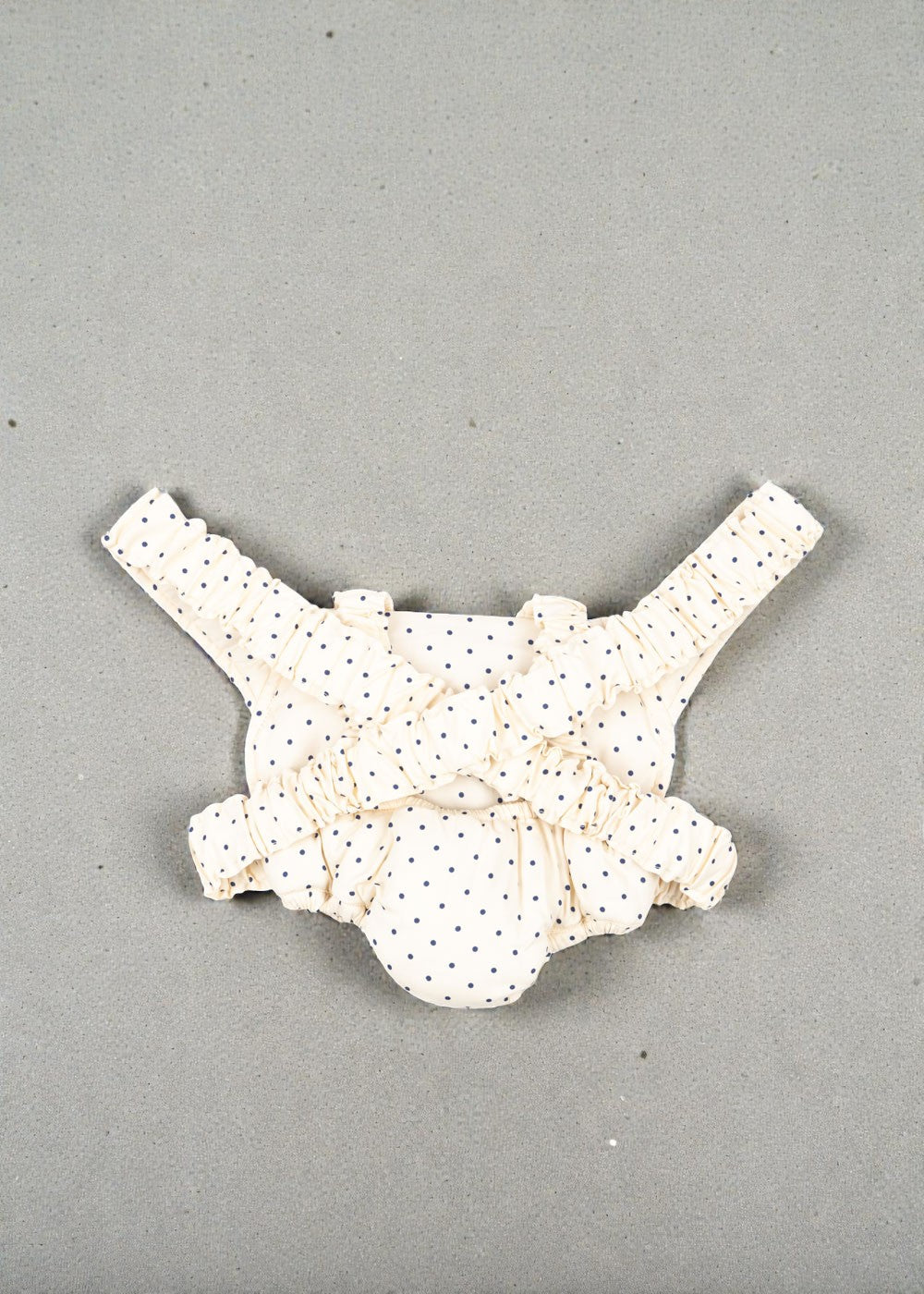 Navy dot baby carrier with elastic shoulder straps for hands-free doll play