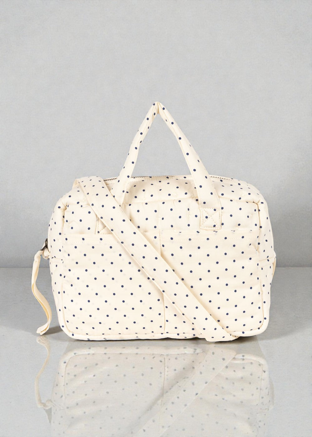 Navy dot tote bag with dual carry options handles and crossbody strap for doll play