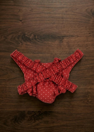 Back view of doll carrier showing adjustable elastic shoulder straps and quilted construction