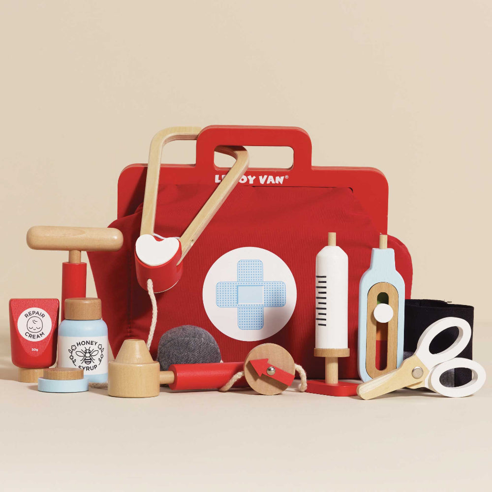 Le Toy Van vintage doctor kit with nine wooden medical tools in red bag