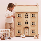 Large four-story Le Toy Van dollhouse in natural wood finish