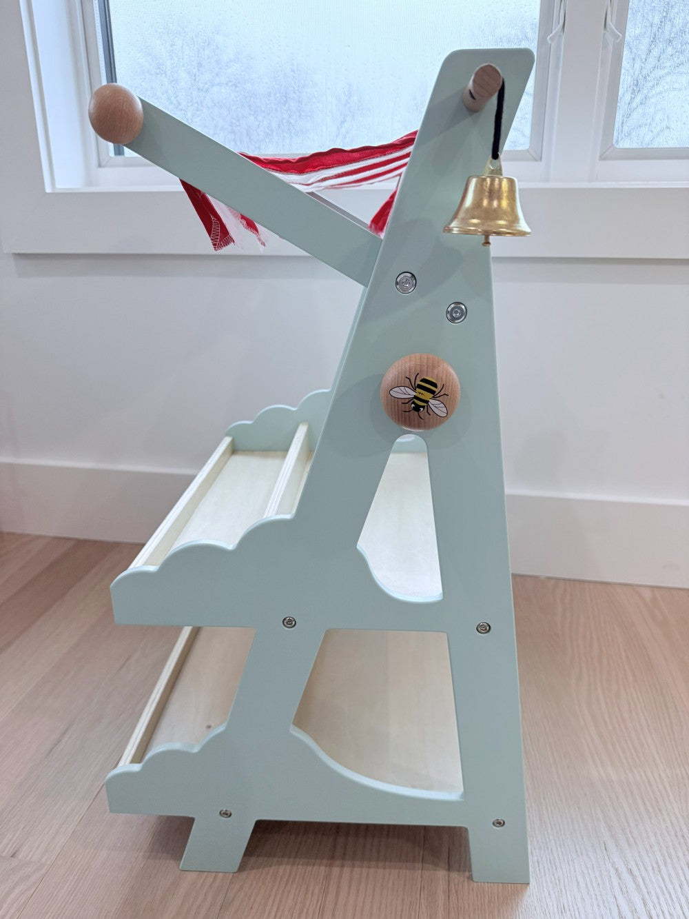 Market stall with a bell on a wooden floor