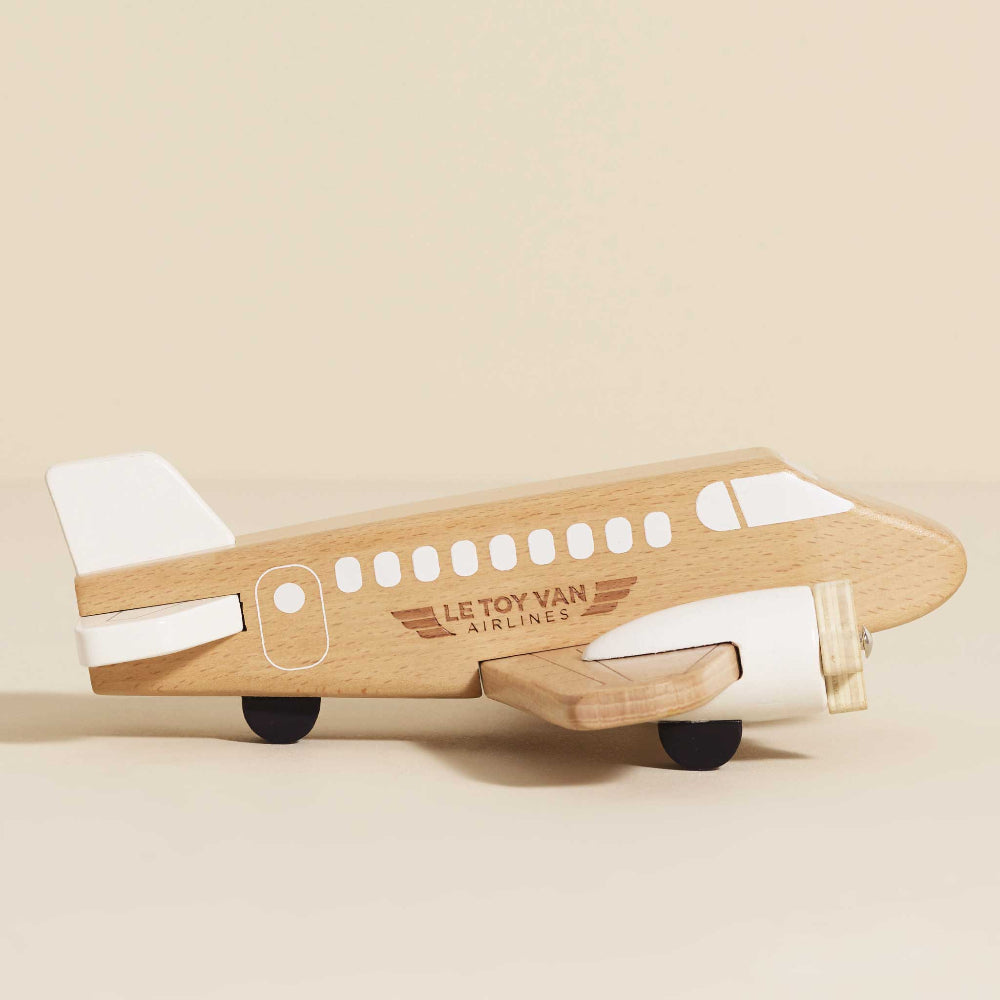 Close-up of FSC-certified wooden plane showing grain and propellers