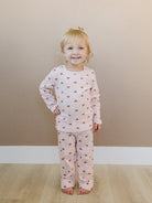 Toddler in sophisticated mauve heart print showing stretchy athletic fit