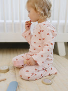 Kid playing in Dreamy Mauve Hearts premium comfort wear with blush pink base