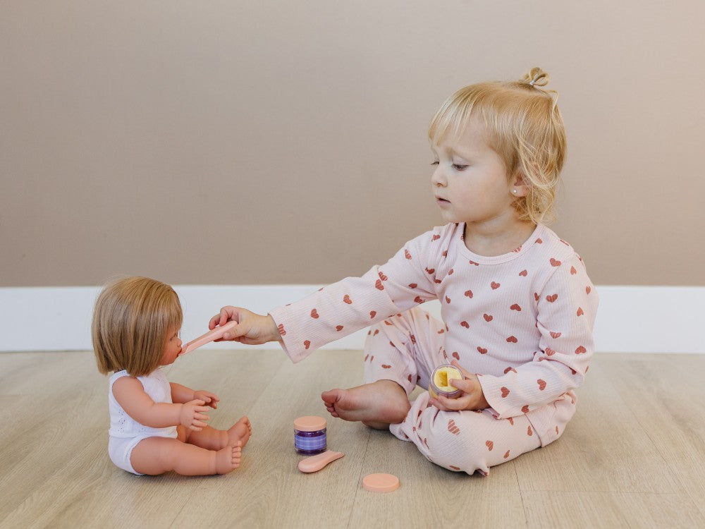 Young child wearing Korean-crafted ribbed set in Dreamy Mauve Hearts pattern