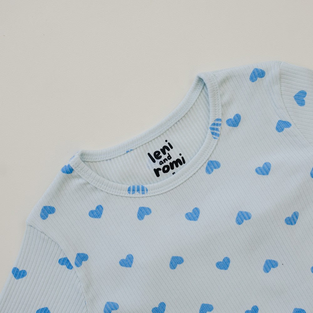 Close-up of Leni & Romi tagless ribbed texture with sky blue hearts scattered pattern