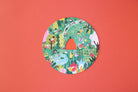 Circular cutout with colorful illustrations on a red background