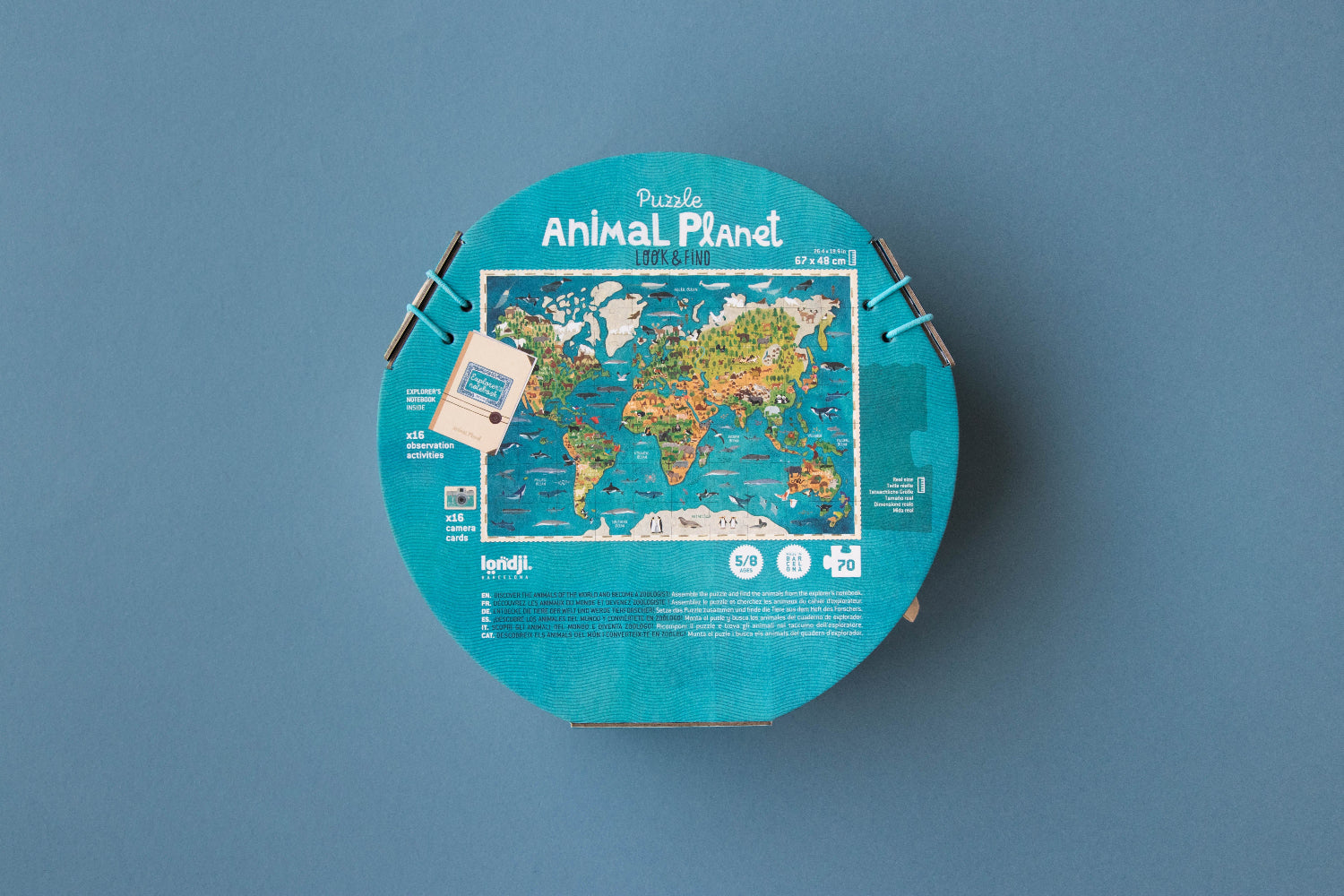 Round puzzle box with world map design on a blue background