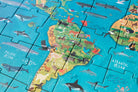 Children's puzzle with a map of the world and animals on a blue background