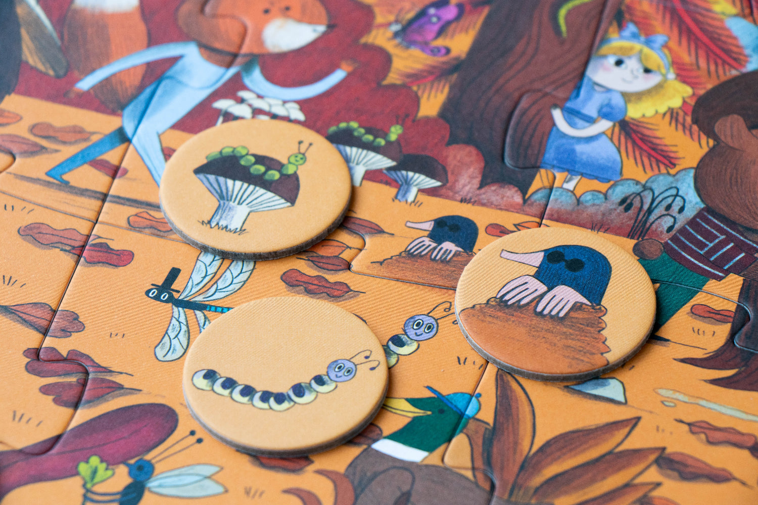 Wooden buttons with animal designs on a colorful fabric background