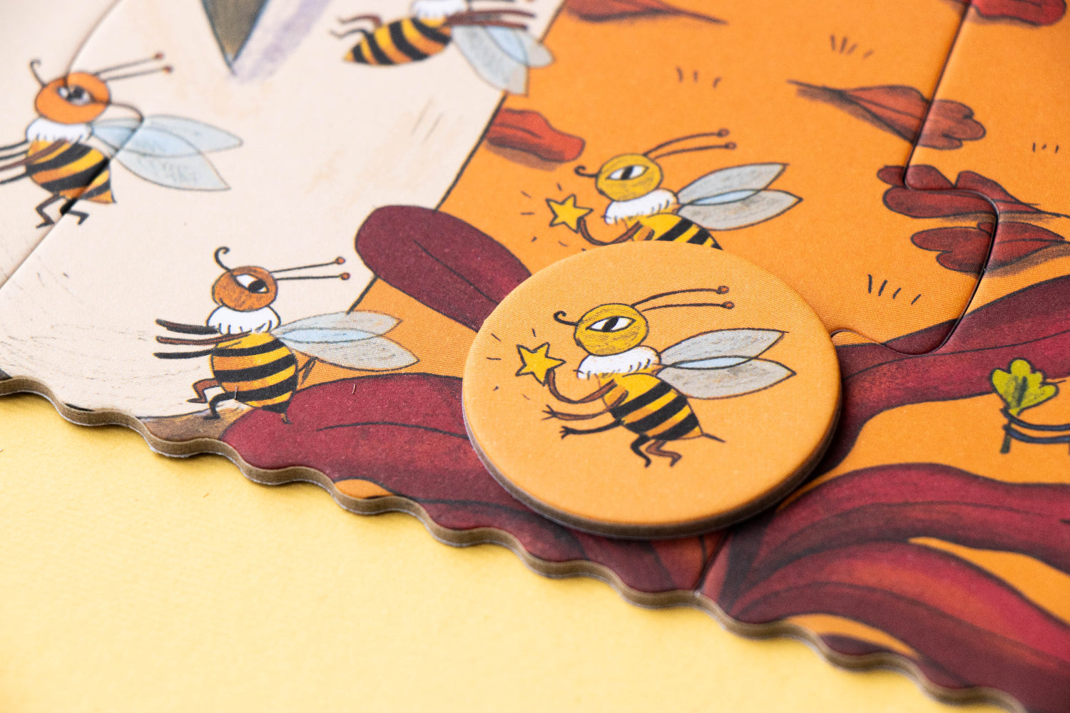 Children's puzzle with bee illustrations on a yellow background