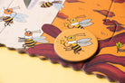 Children's puzzle with bee illustrations on a yellow background