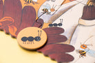 Wooden puzzle piece with an ant design on a colorful background