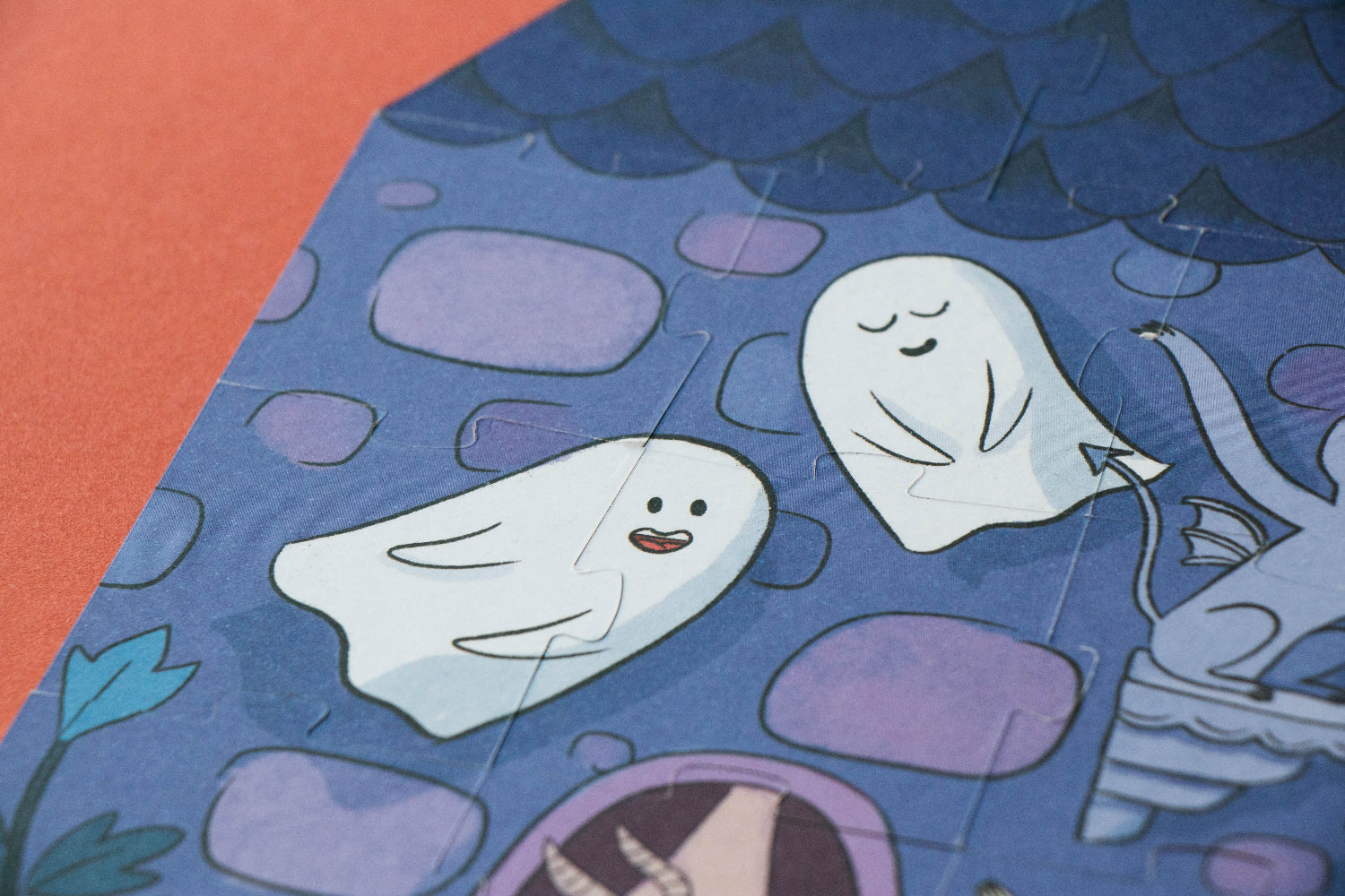 Illustration of two ghosts and a cat underwater with fish and bubbles.