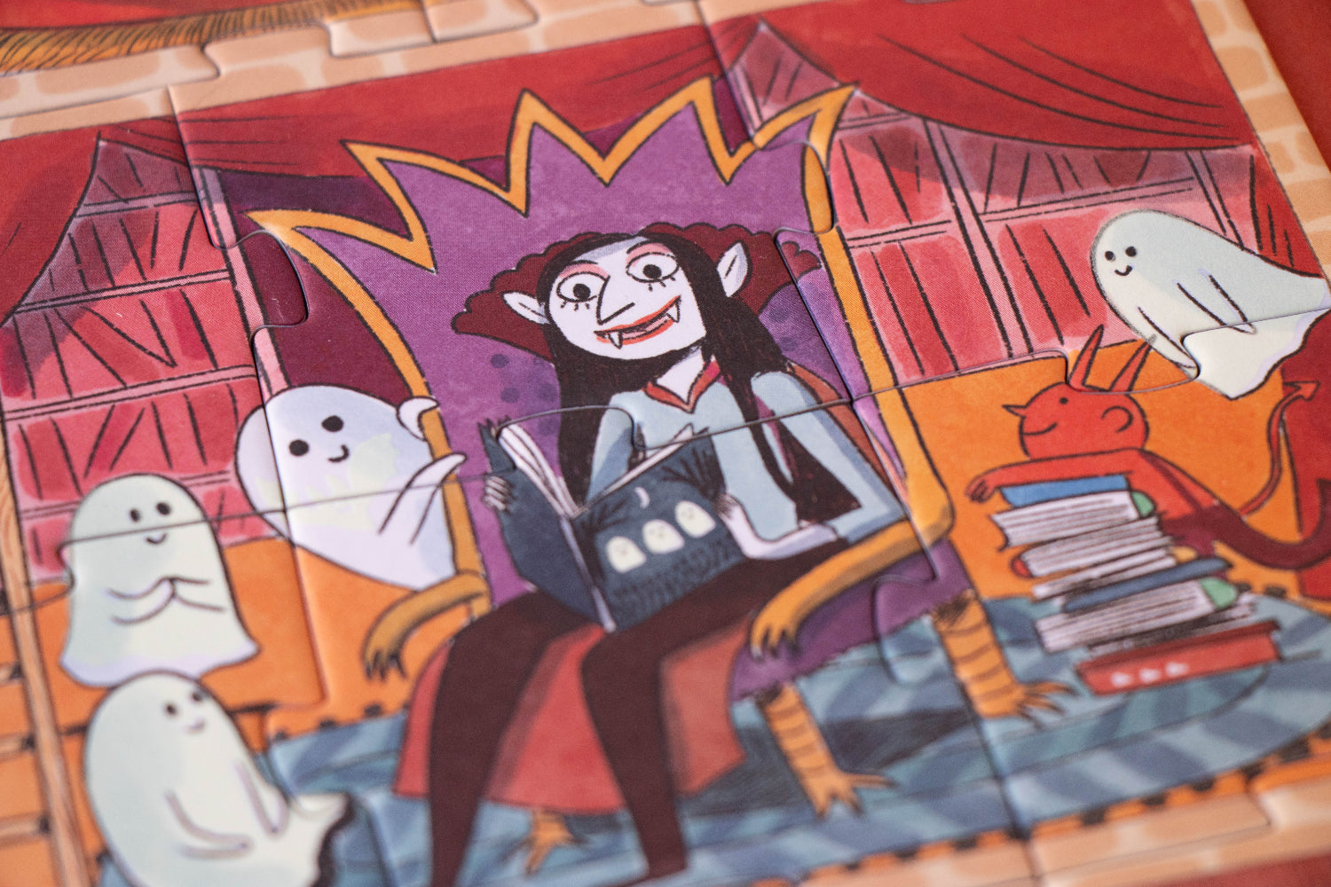 Halloween-themed puzzle with a witch and ghosts on a wooden surface