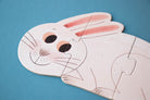 Cartoon bunny face cutout on a blue background