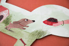 Children's book illustration with a dog and a hand holding a bone on a red background