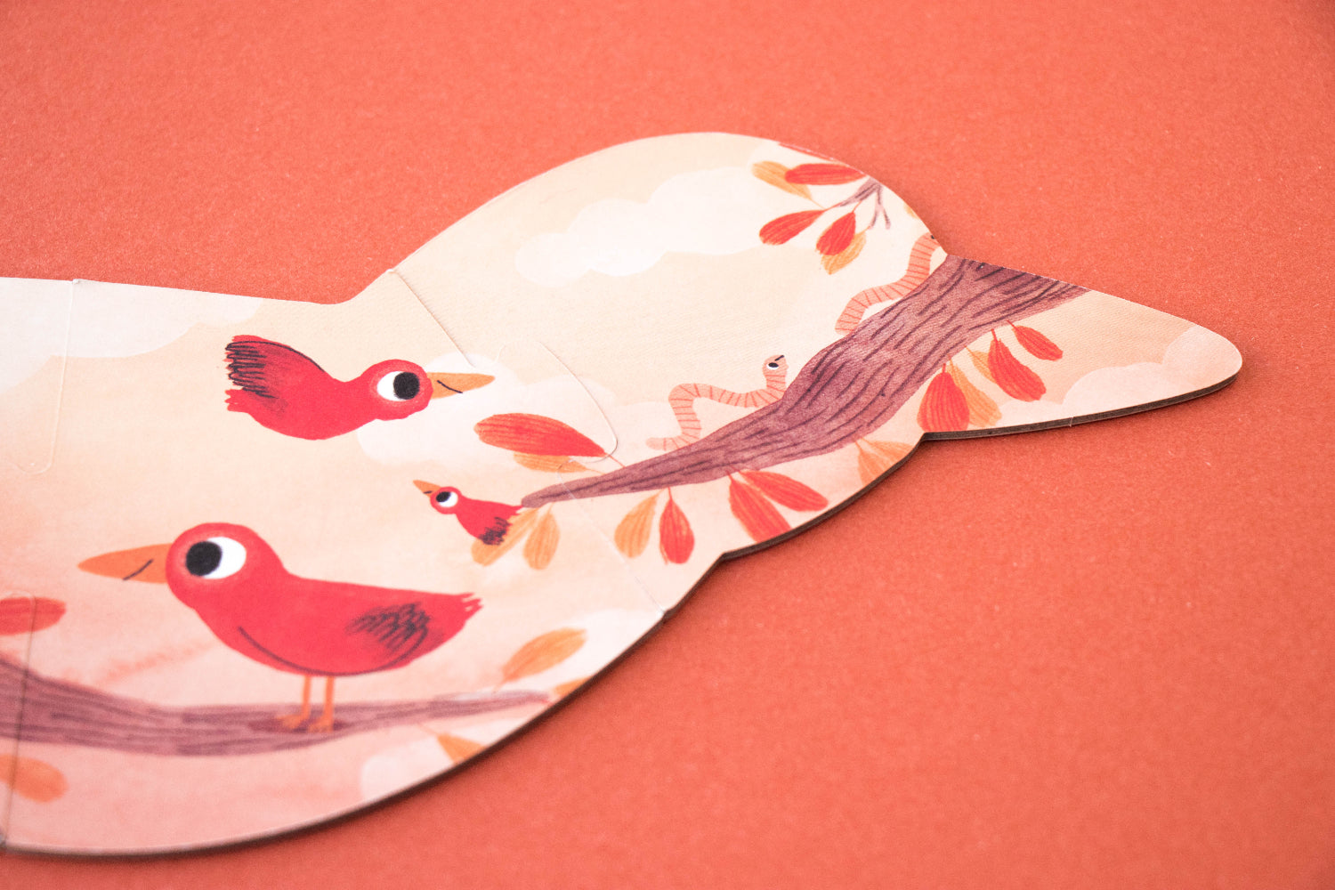 Puzzle with bird design on a coral background