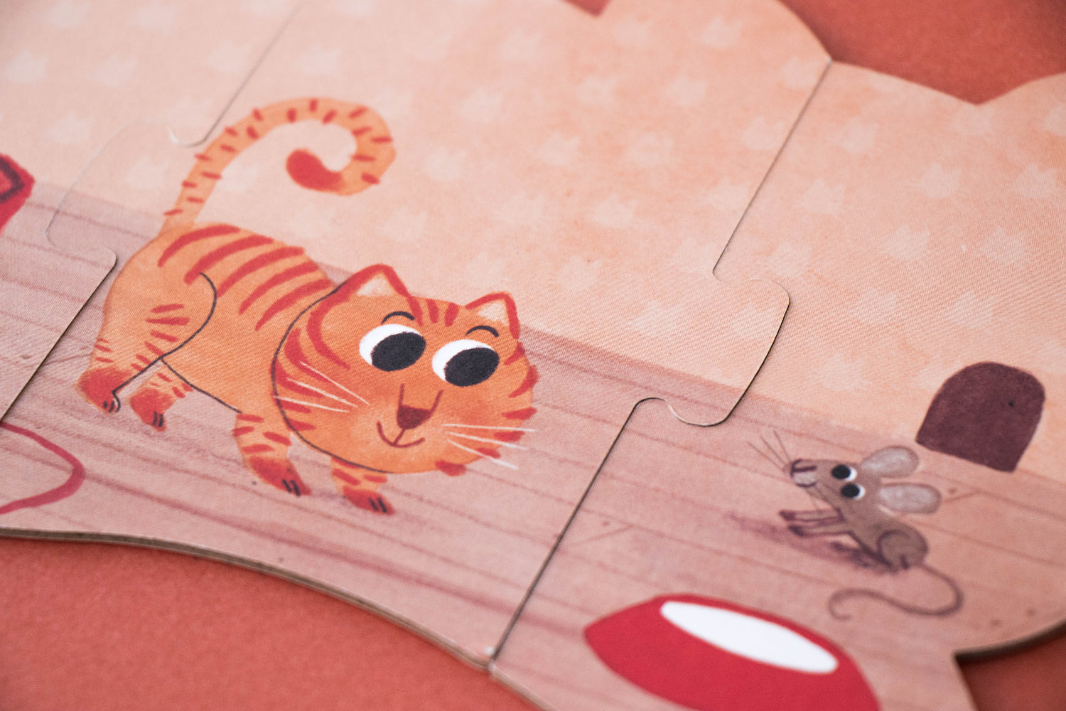 Children's puzzle with cartoon tiger and mouse on a wooden surface