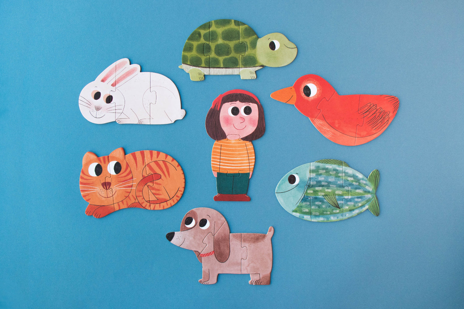 Set of colorful animal and character puzzles on a blue background