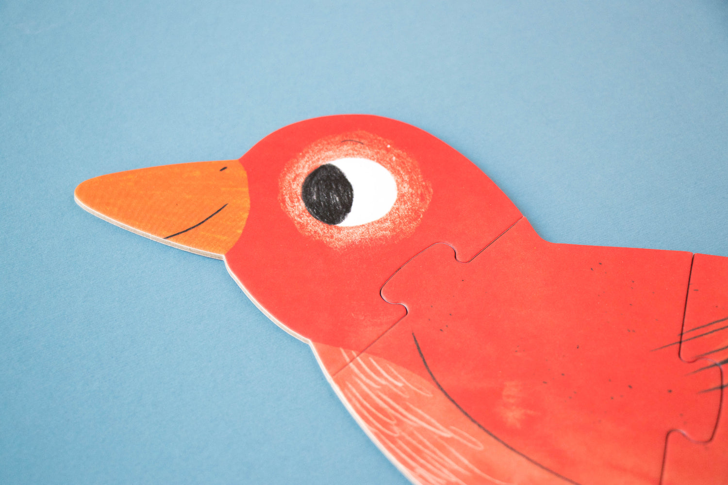 Red bird-shaped puzzle piece on a blue background
