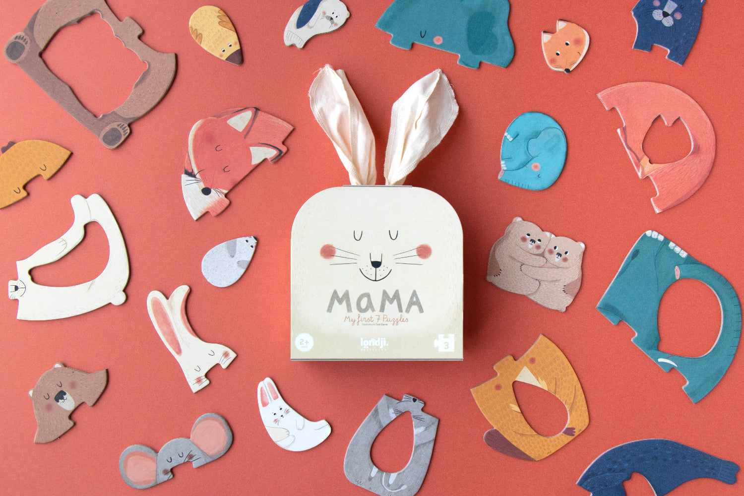 Londji Mama puzzle set showing 7 shaped mama and baby animal puzzles on a coral background