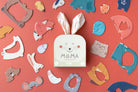 Londji Mama puzzle set showing 7 shaped mama and baby animal puzzles on a coral background