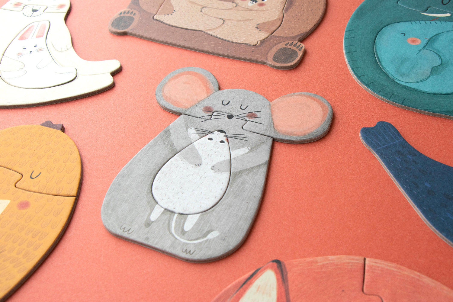 Collection of animal-shaped puzzles on a pink surface