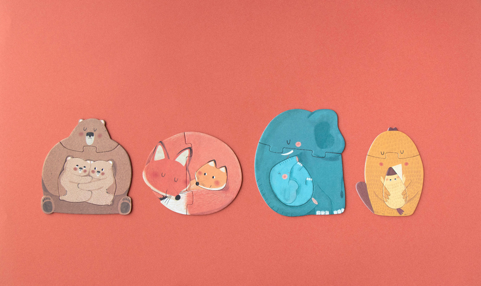 Four animal-shaped puzzles on a red background