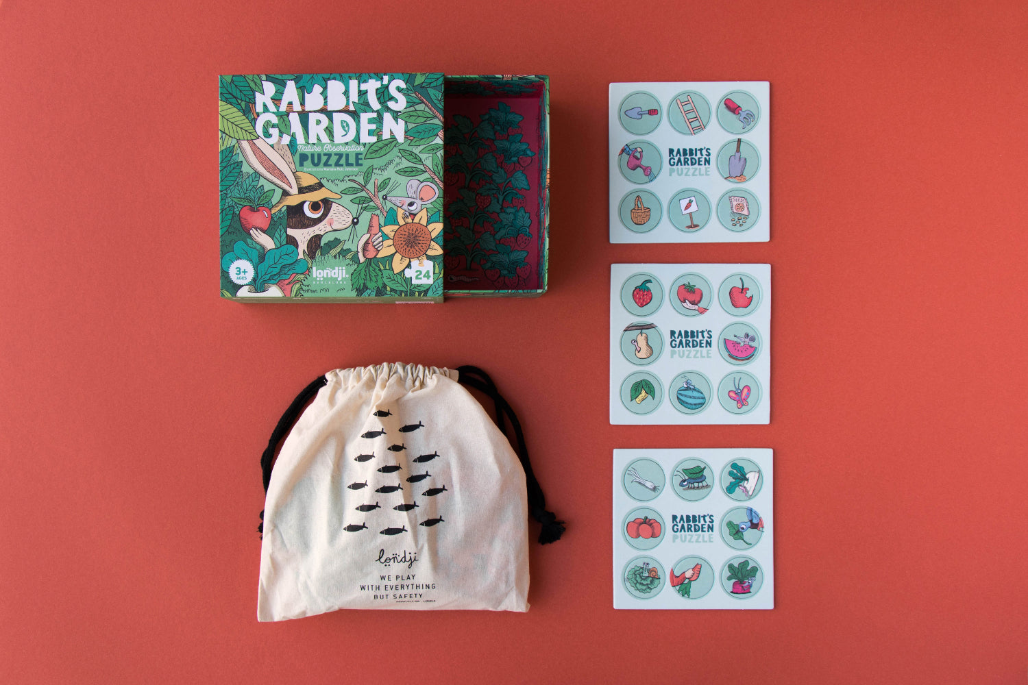 Educational children's products including a puzzle, drawstring bag, and sticker sheets on a red background