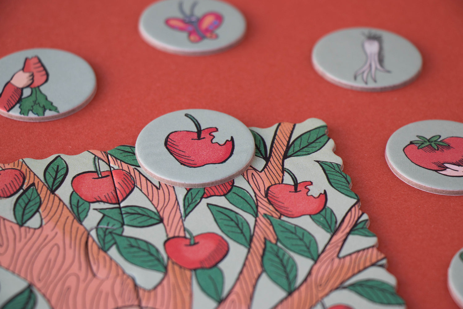 Decorative buttons with apple designs on a red background