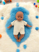 African American Baby Doll on a blue rug