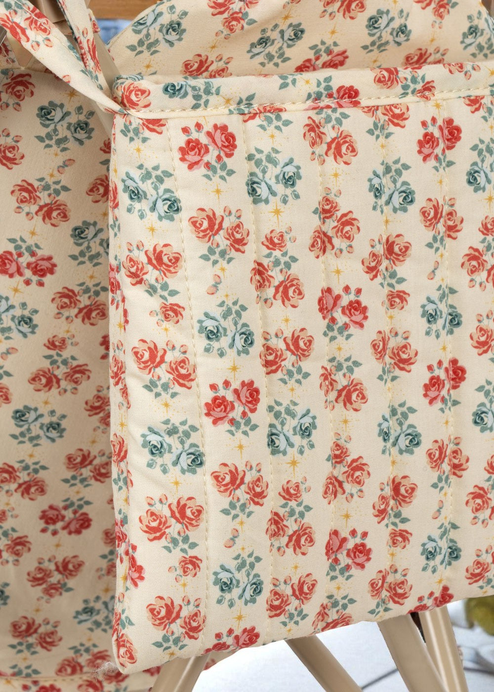 European-design doll stroller showing storage basket and collapsible frame construction