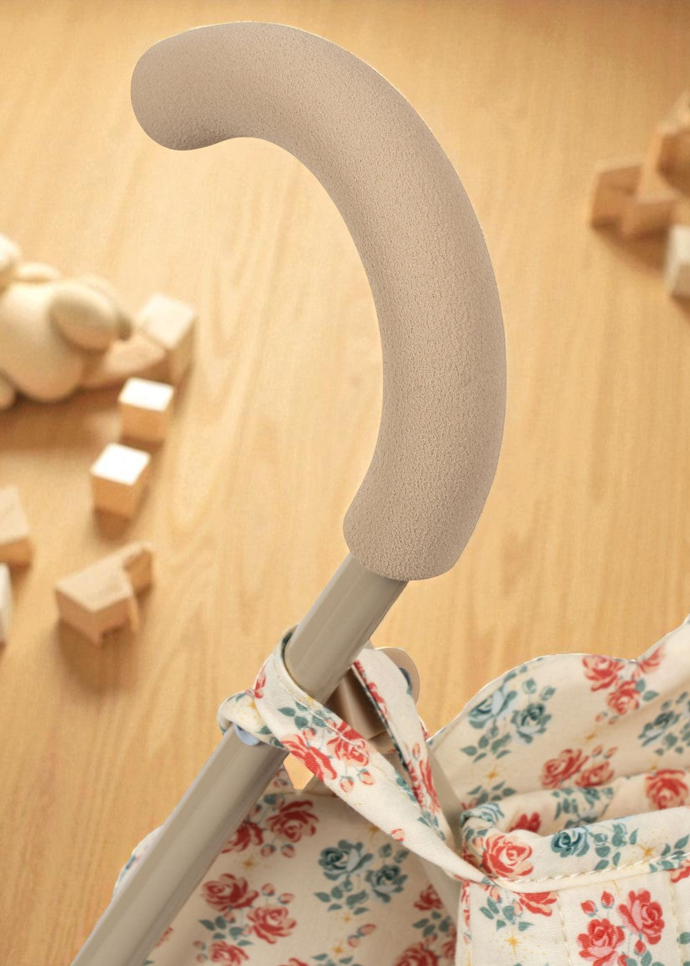 Collapsible doll stroller frame detail showing fold mechanism and iron construction
