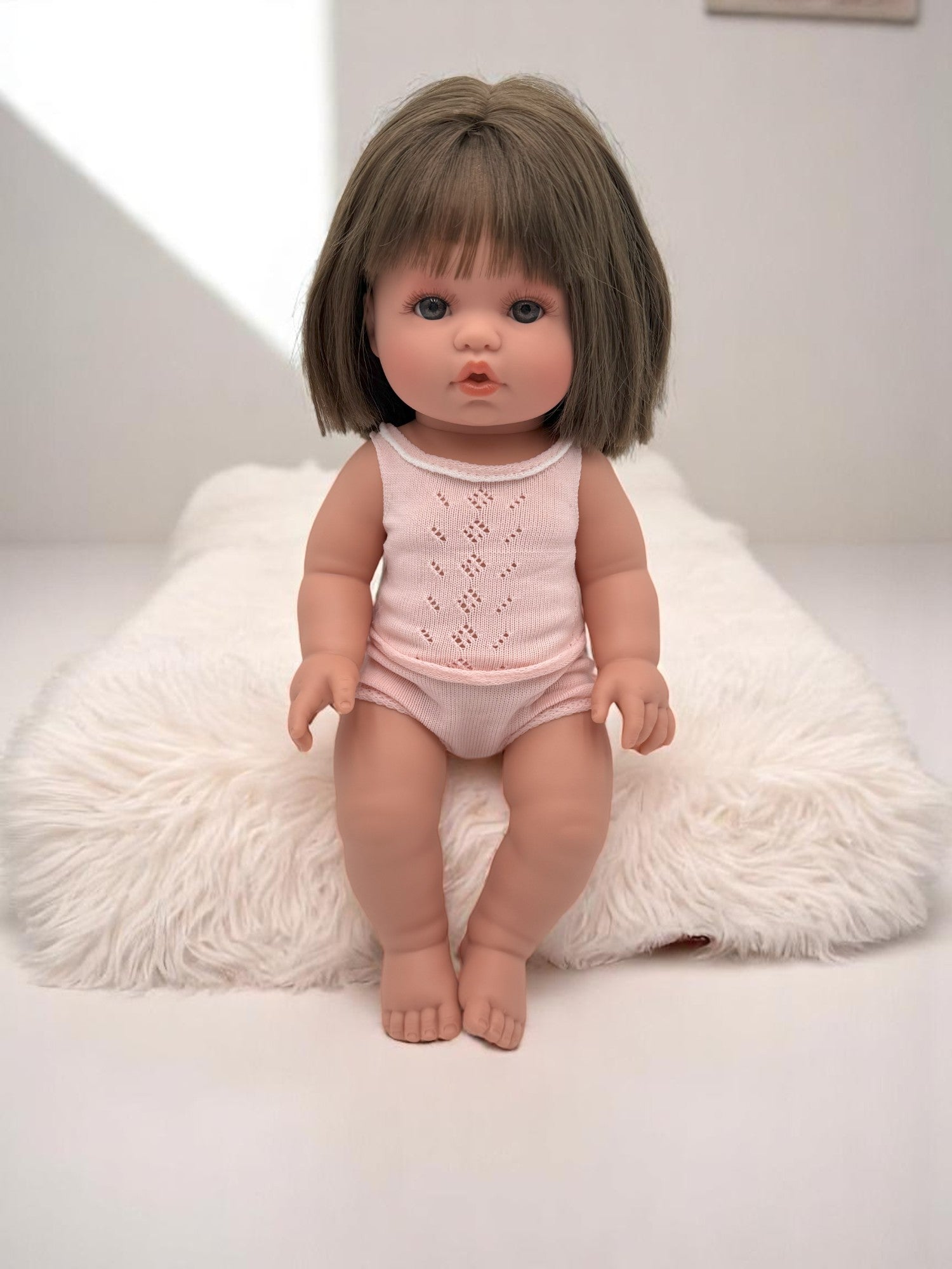 Lifelike baby doll Milan with brunette bob haircut perfect for children's playroom nurturing activities