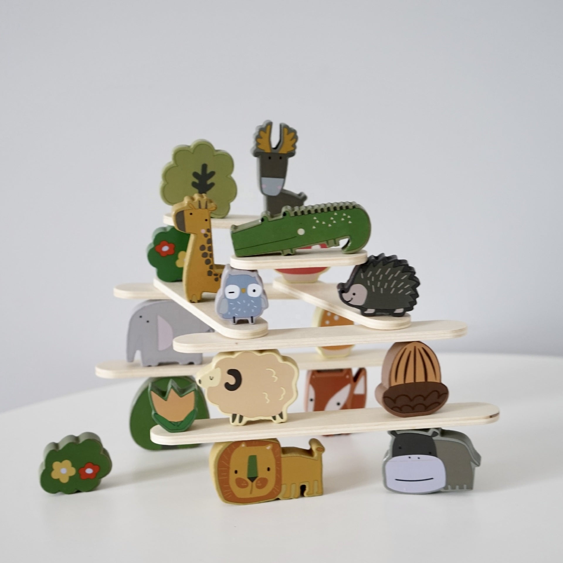 Wooden animal stacking blocks balanced on platforms demonstrating Montessori balancing activity