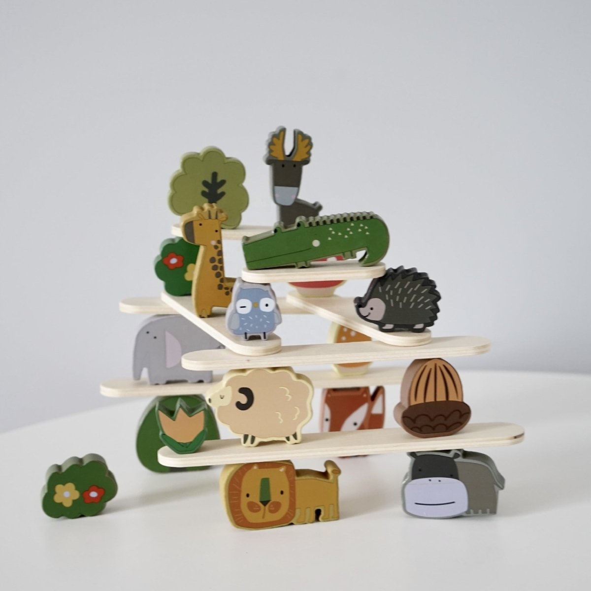 Wooden animal stacking blocks balanced on platforms demonstrating Montessori balancing activity