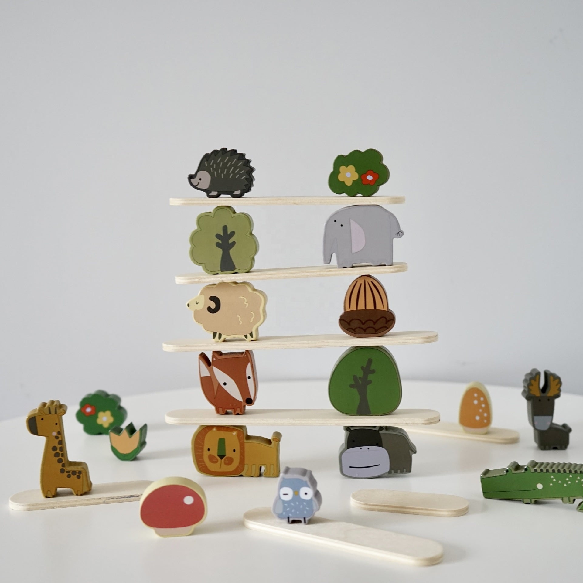 Forest-themed Montessori stacking blocks with various animals, mushrooms, and trees for creative play