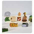 Individual wooden Montessori stacking blocks showing forest animals including fox, sheep, and giraffe