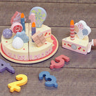 Montessori pretend play birthday cake showing colorful pastel pieces and serving plate