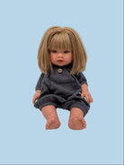 Handmade navy doll romper laid flat showing one-piece silhouette, elasticated cuffs, and button detail