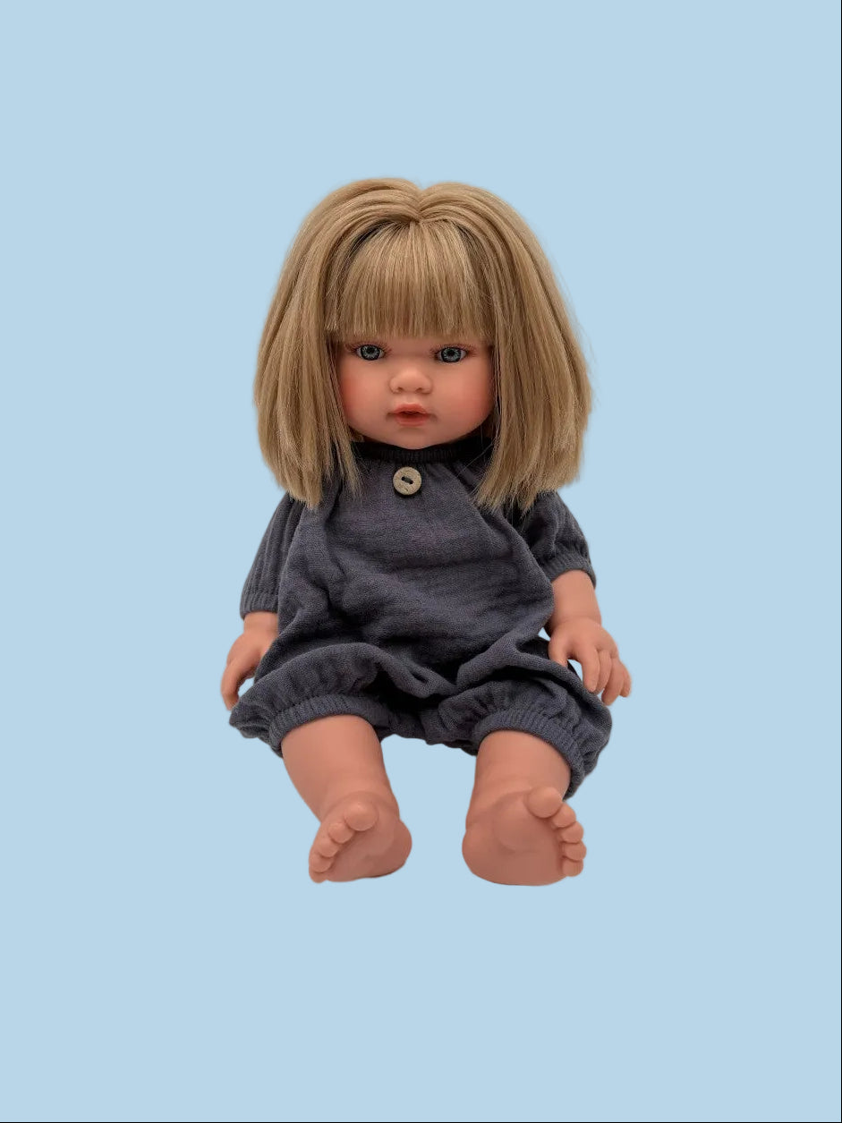 Handmade navy doll romper laid flat showing one-piece silhouette, elasticated cuffs, and button detail