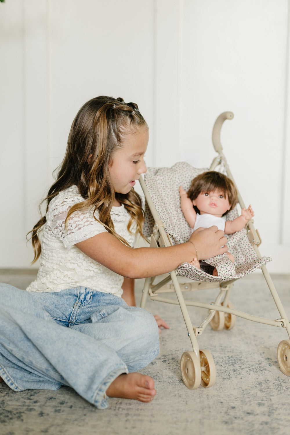 Older Girl Tucking Doll in Stroller