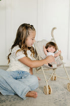 Older Girl Tucking Doll in Stroller