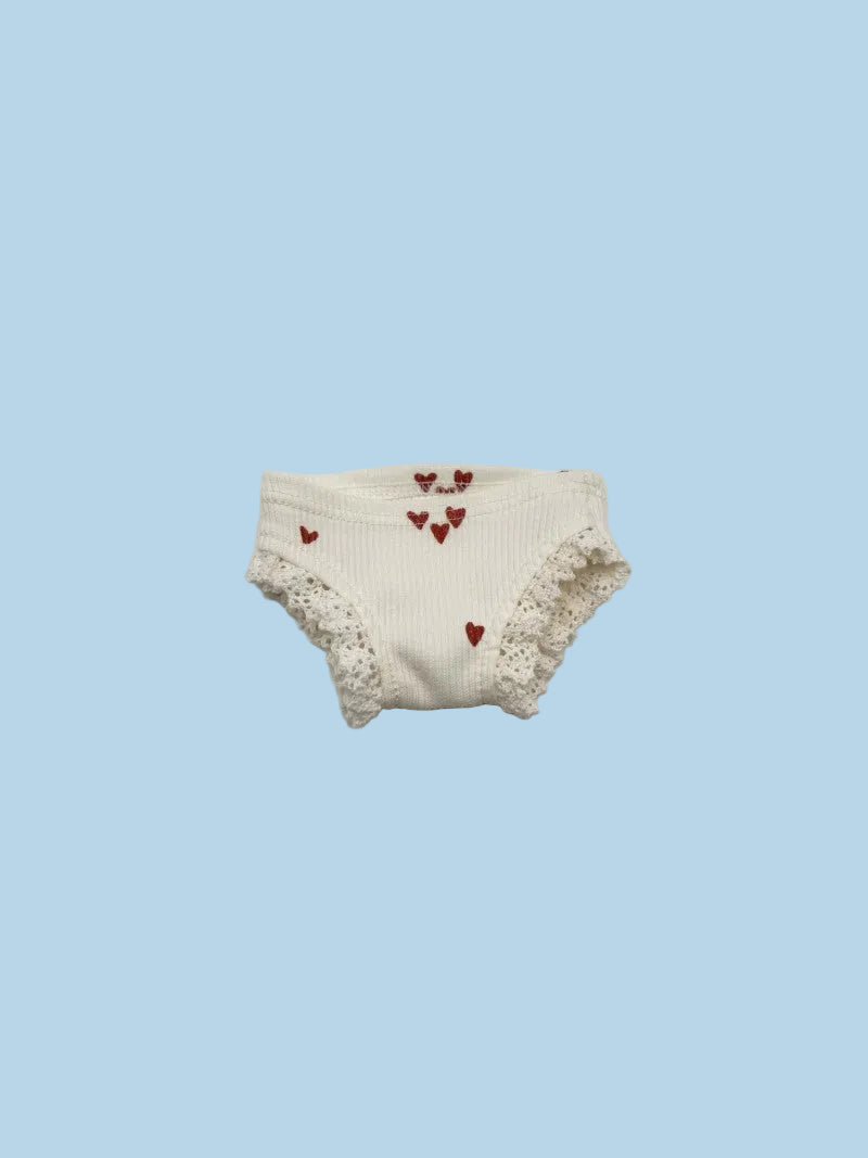 White baby bloomers with red heart patterns