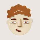 Close-up of PlanToys Build a Face two-sided components with different emotions