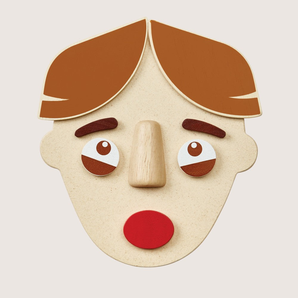 Close-up of PlanToys Build a Face two-sided components with different emotions