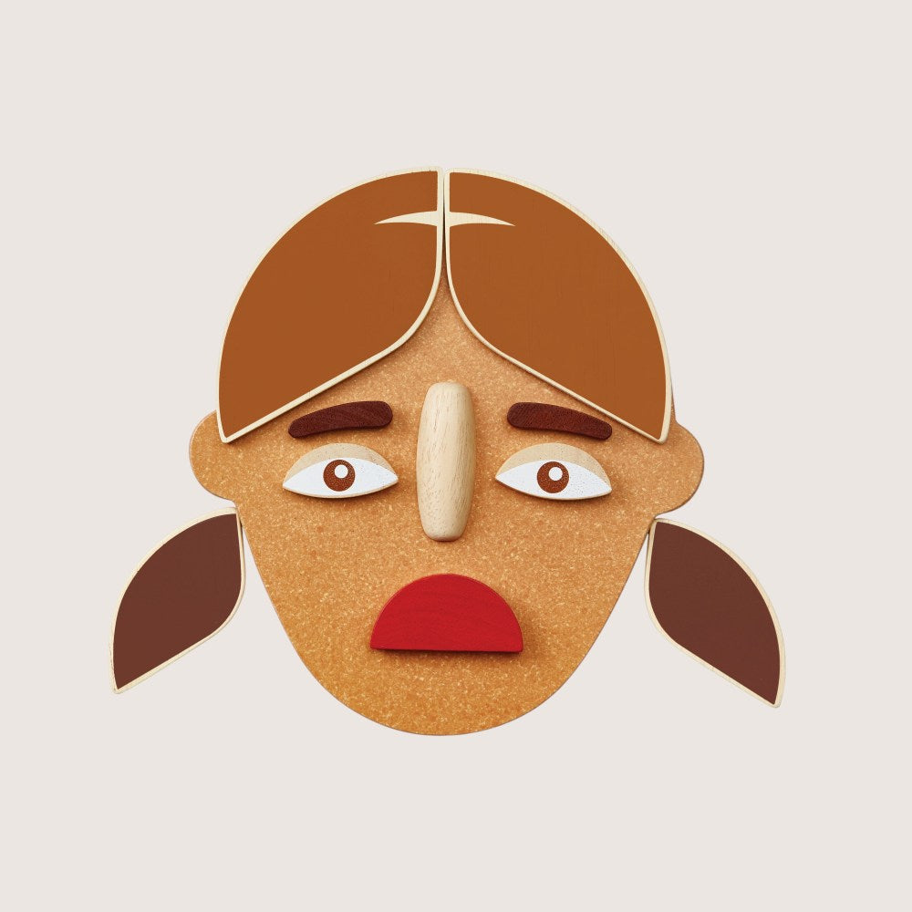 Close-up of PlanToys Build a Face two-sided components with different emotions