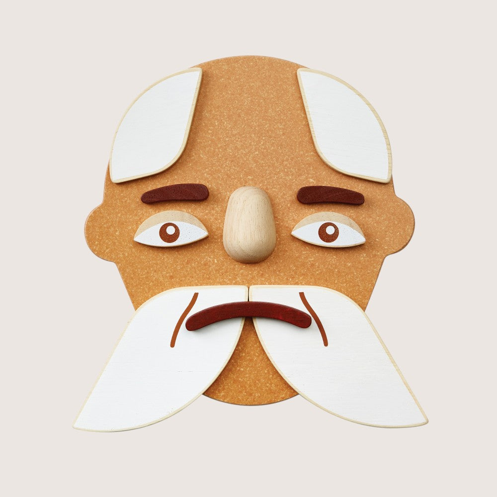 Close-up of PlanToys Build a Face two-sided components with different emotions